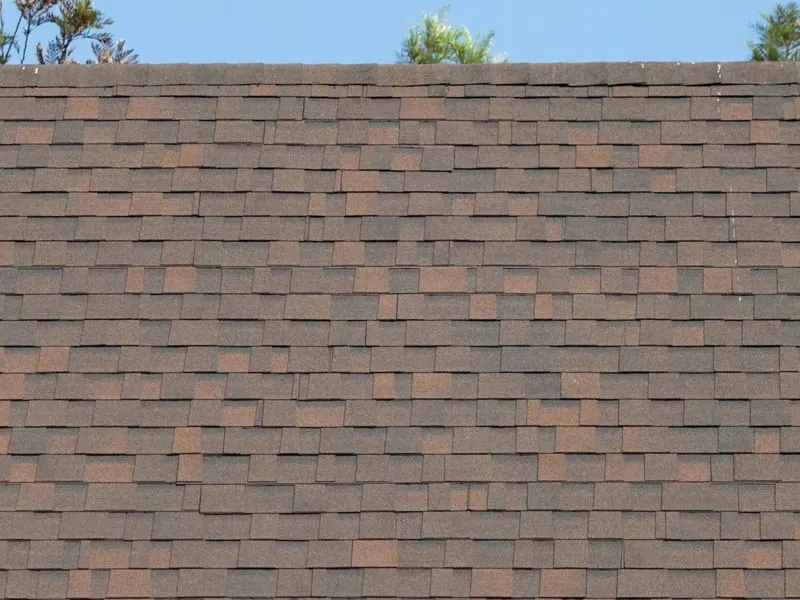 Close-up of a newly installed brown architectural shingle roof on a Lake Havasu City home